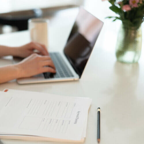 Stephanie O'Keefe Seo Strategist Working On Header Tag Optimization On Laptop In Kitchen.