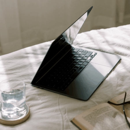 laptop at home on bed while working on website crawling and indexing